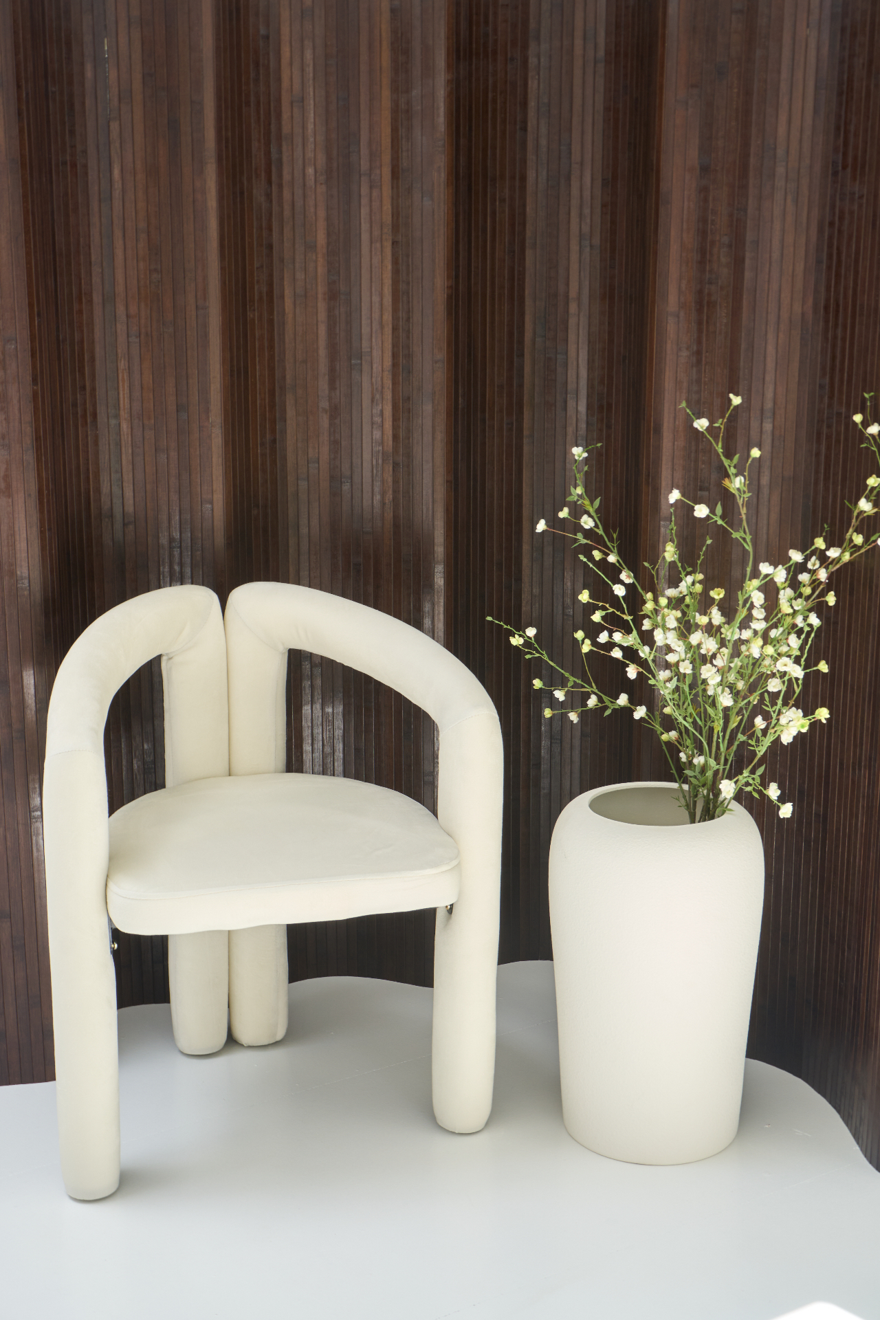 Cream bouclé chair against wood slat backdrop at Selectively Social content studio Glasgow