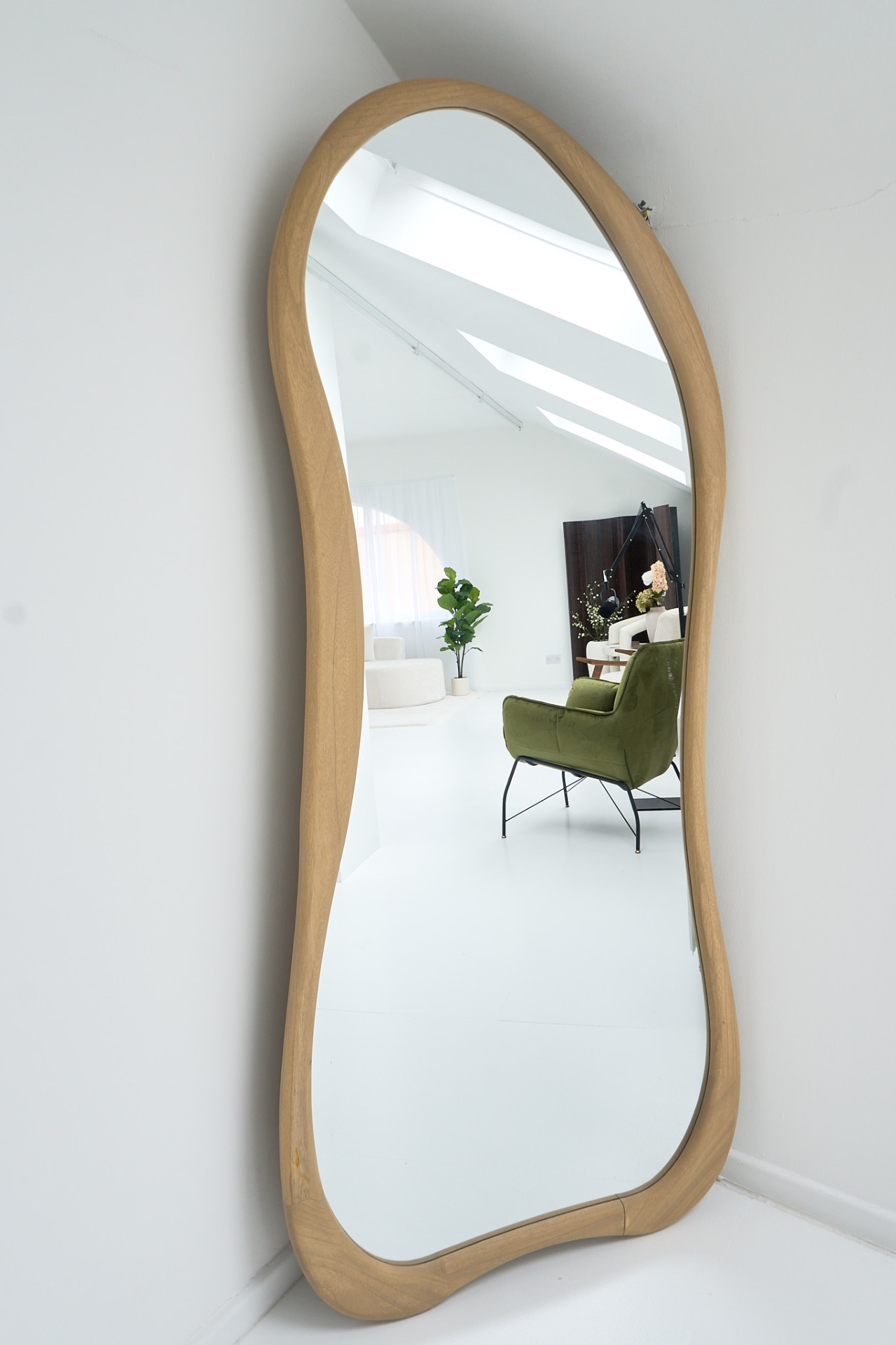 Organic wood-framed mirror reflecting the Glasgow content studio interior