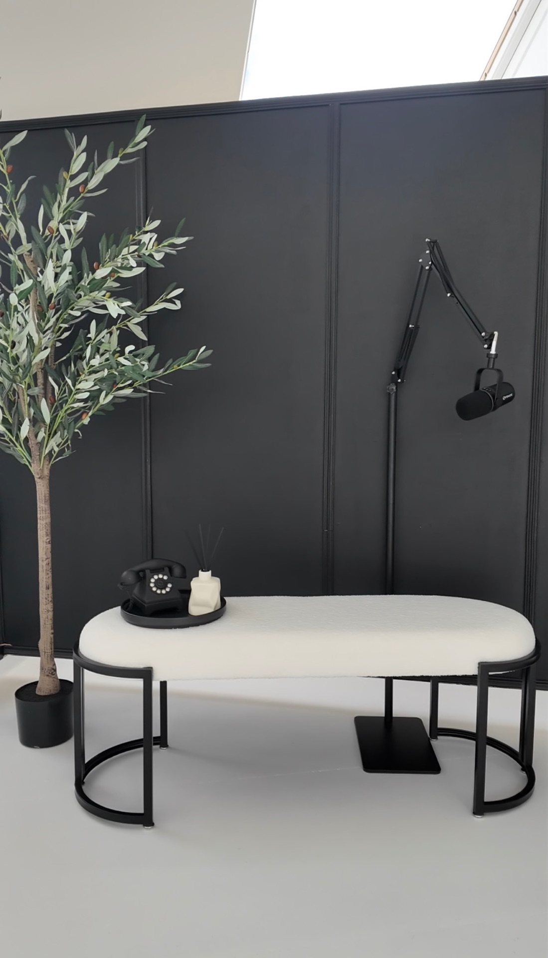 Black podcast set with bouclé bench and boom mic at our Glasgow content studio